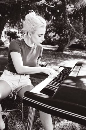 Lady Gaga from the Joanne booklet, jamming out on electric piano as heard on "Come To Mama"